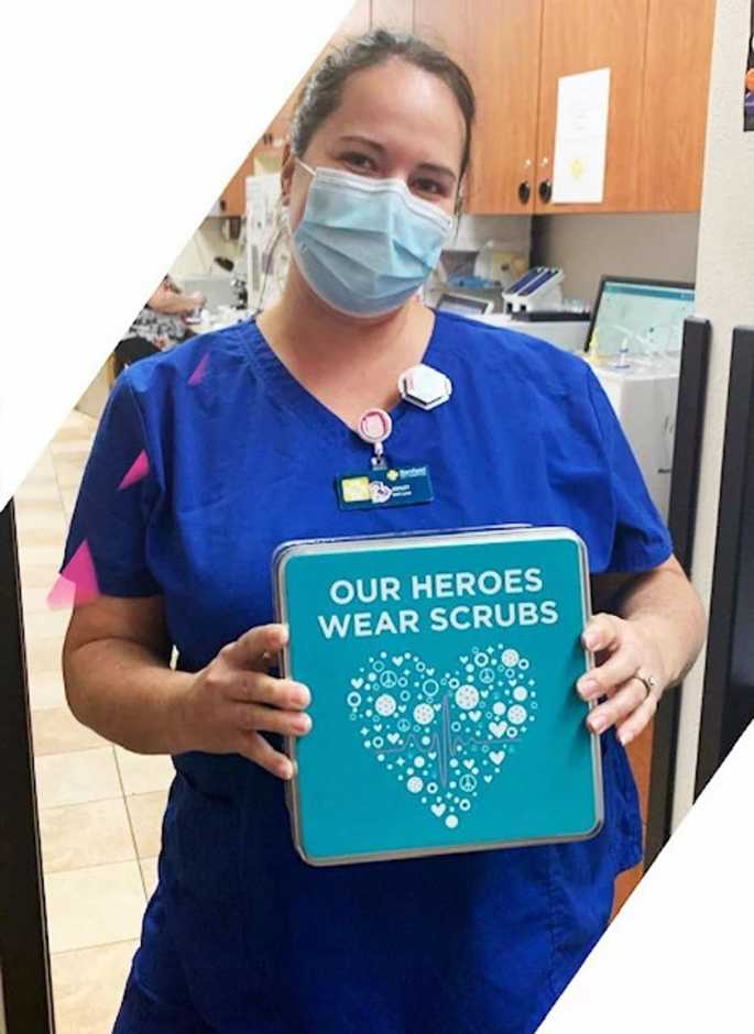 A young female associate holding a placard at the Banfield Pet Hospital