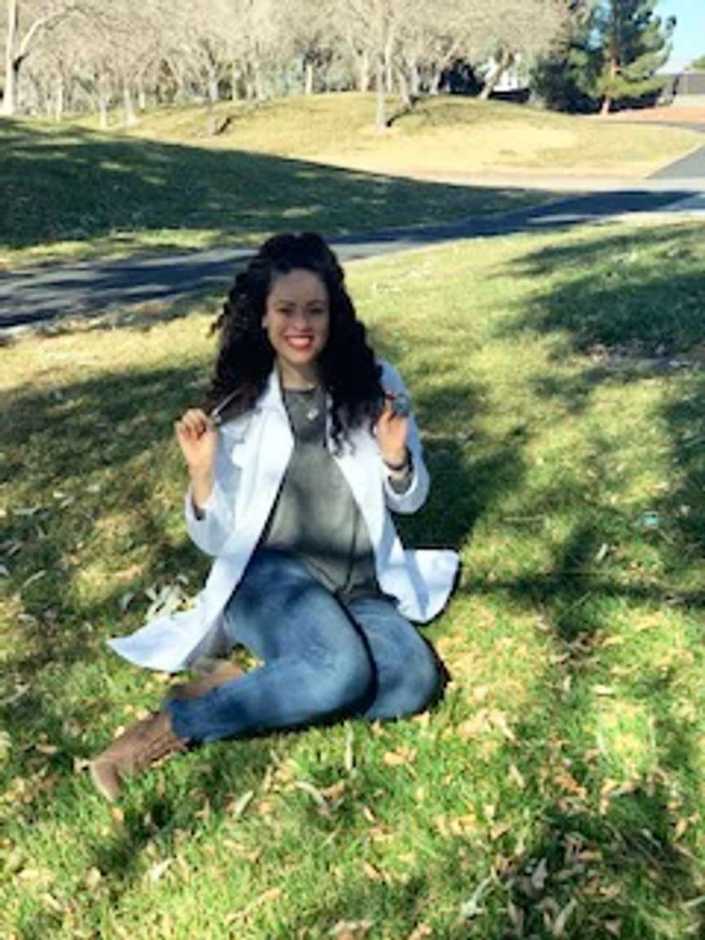 A young female Banfield veterinarian sitting in the park