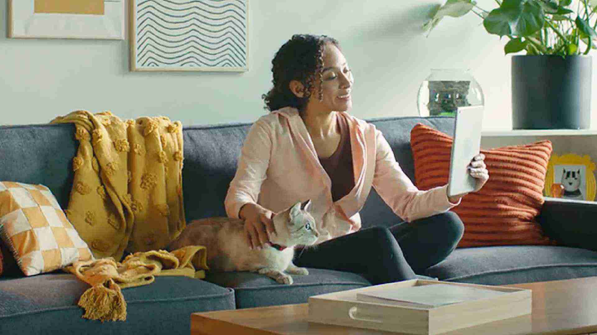 Woman and her cat at home, benefiting from convenient virtual petcare option